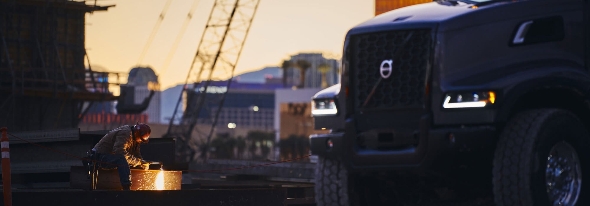Man Welding next to Volvo Truck